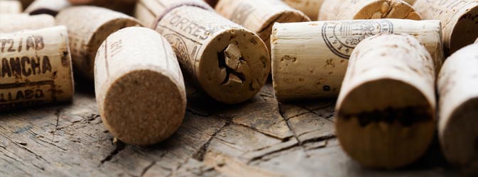 wine corks scattered on wooden surface